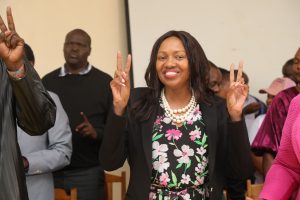 Governor Susan Kihika engaging community development forum in Kuresoi North, with leaders beside her